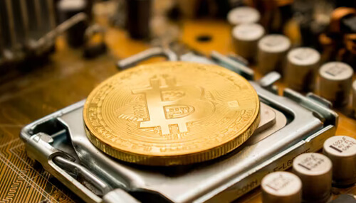 Bitcoin mining A close-up of a bitcoin coin on a circuit board, illustrating the connection between cryptocurrency and bitcoin mining technology.