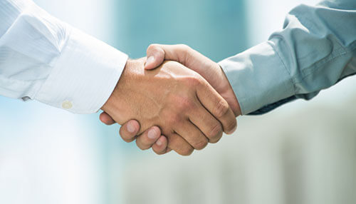 Partnership numbers - tycoonstory | tycoonstory media Close up of two people shake hands, it symbolizing that business ecosystems partnership.