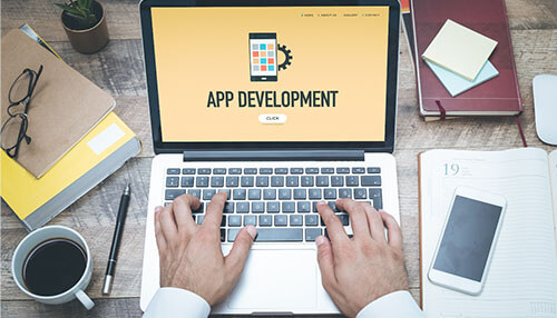 Execute your app idea Mobile app development concept showing app creation on laptop with design tools and programming workflow