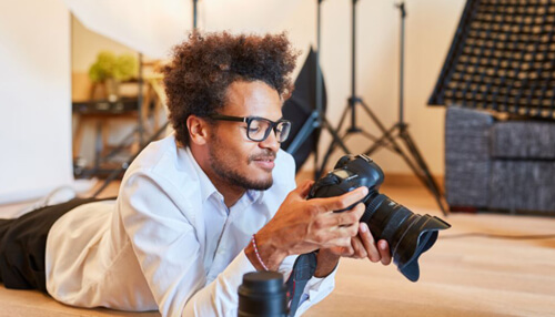 Burst mode is a good option for photographing moving subjects A clean, professional white-out photography studio with large softboxes and a makeup station, perfect for capturing great pictures.