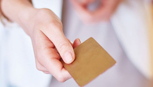 Credit reward card Customer holding a credit reward card during a purchase, representing everyday rewards and secure payments.