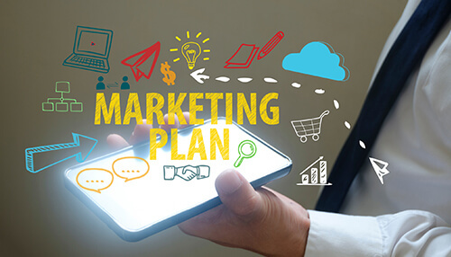 A person holding a smartphone with the text'MARKETING PLAN' displayed, surrounded by colorful icons representing various marketing elements Create a marketing plan to plan for your coaching business