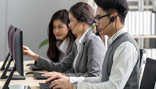 Features of contact centers - tycoonstory | tycoonstory media Customer support team using call center software while working at computers with headsets in a call center environment.