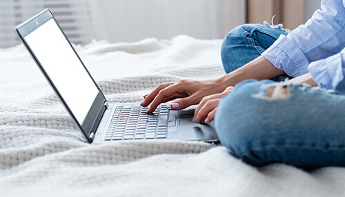 Freelance Person working on a laptop from home, exploring ways to make money online and offline through digital opportunities