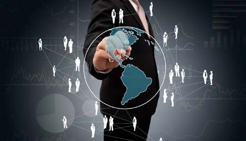 Investor network - tycoonstory | tycoonstory media Business professional pointing at a digital network map, representing the global reach of angel investors for small business funding and connection opportunities