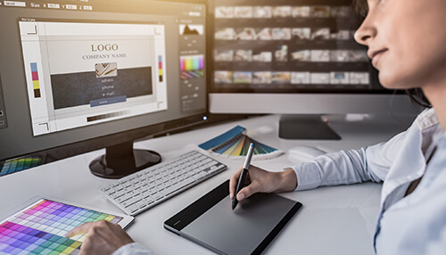 Graphic designer working on a computer with design software, creating a professional logo for business branding Order the best-quality and well-defined logo for your website with graphic design