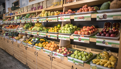 Image of a vibrant display of fresh fruits and vegetables in a grocery store, showcasing a variety of produce options | tycoonstory media Organic market food business ideas
