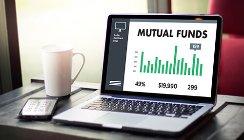 Outline the investment terms - tycoonstory | tycoonstory media Laptop displaying a financial graph with mutual funds on the screen, showing investment data and statistics