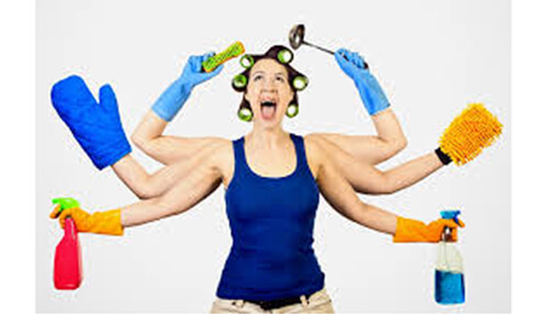 Prioritize - tycoonstory | tycoonstory media Woman multitasking with cleaning tools and gloves, representing the challenges of trying to clean your house efficiently.