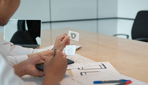 Use simple and clear web design Ux designer arranging interface sketches and icons during user experience planning and testing.