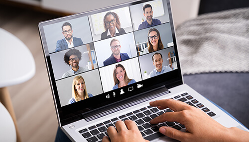 Call a private meeting Person attending an online video meeting with professionals, participating in virtual business networking on a laptop.