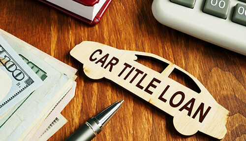 Car title loan - tycoonstory | tycoonstory media A close-up of a document with a red "approved" stamp, white letter blocks spelling "loan," and a set of car keys, representing a successful vehicle financing application.