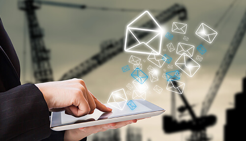 Email course - tycoonstory | tycoonstory media Lead generation: a person's hand using a tablet with glowing digital envelope icons floating above it.