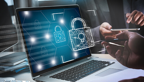 How to ensure safety against fileless attacks Laptop displaying digital lock icons and cybersecurity interface, illustrating protection and monitoring against fileless cyberattacks