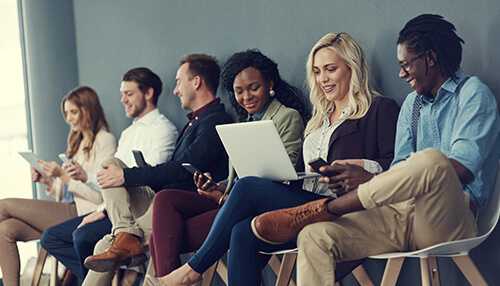 Identify the candidate’s potential Diverse group of people waiting in a line, symbolizing recruitment strategies to build a varied and skilled team for business success.