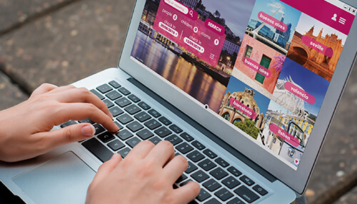 Improve the user experience on your hotel's Website Person browsing a travel website on a laptop, searching for luxury resort destinations around the world.