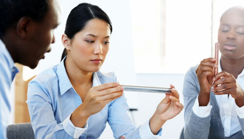 Keep product quality a top priority - tycoonstory | tycoonstory media Team of professionals analyzing materials in a meeting to strategize on keeping up with product demand and improving manufacturing efficiency.