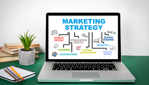 B2b vs b2c marketing Laptop displaying a marketing strategy with a focus on b2b and b2c optimization, planning, and traffic building for effective marketing.