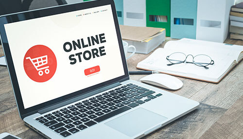 Online store A laptop displaying an online store homepage, illustrating the process of setting up a print-on-demand ecommerce store to sell custom products.