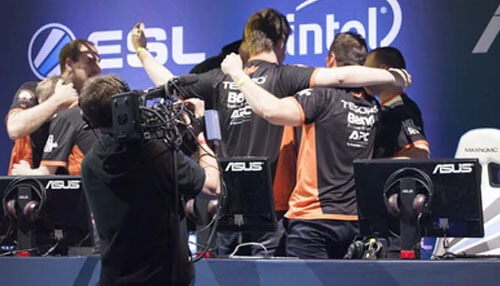 Sunpayus - tycoonstory | tycoonstory media Esports team triumphing on stage at iem cologne, powered by esl and intel, a cameraman capturing the scene.