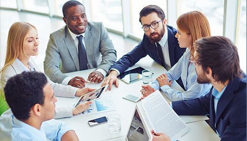 Communication - tycoonstory | tycoonstory media A diverse group of employees in a meeting discussing strategies to improve employee productivity and workplace efficiency.