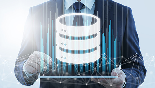 Create a product database Business professional analyzing data and managing databases, with a digital representation of a server stack, showcasing the backend of an ecommerce business.