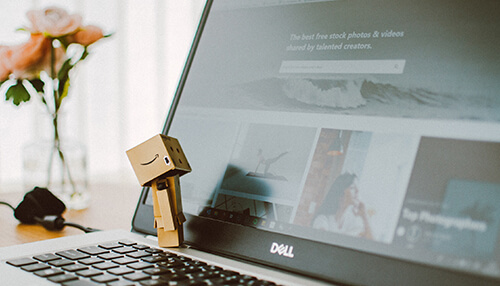 Small businesses use its services daily Laptop displaying a website with images related to business statistics, symbolizing the digital tools used for tracking business performance.