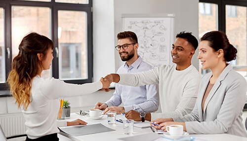 Define job prior to hiring Job interviews handshake between candidate and interviewers, symbolizing successful candidate selection in a professional interview setting.