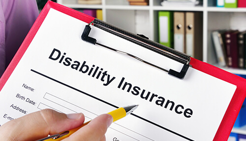 Disability insurance Disability insurance form on a clipboard being filled out, related to workers' Compensation claims, employee injury benefits, and workplace insurance coverage.