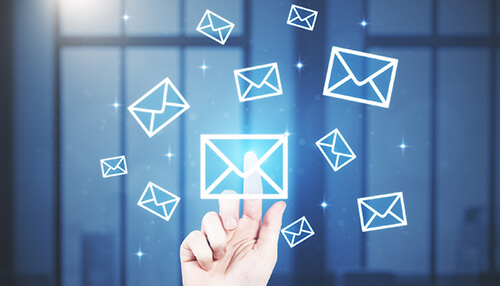 Make use of email marketing A hand interacting with floating email icons, representing digital marketing and engaging promotions through email campaigns.