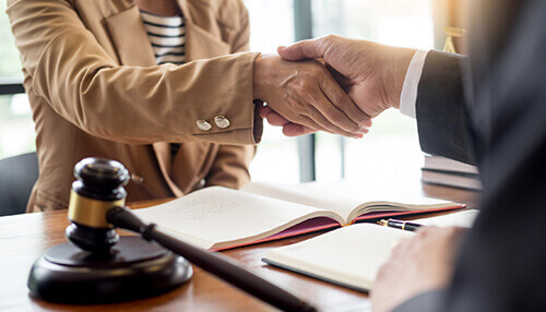 It builds trust Lawyer and client shaking hands after a discussion, symbolizing trust and transparency between lawyer and client