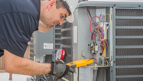 You have more dust on your property Technician inspecting and testing an air conditioning unit using diagnostic tools and electrical gauges.
