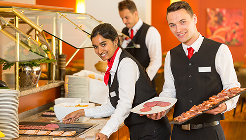 Food manufacturing business ideas Restaurant staff serving freshly prepared dishes, representing food manufacturing business ideas in the food service industry