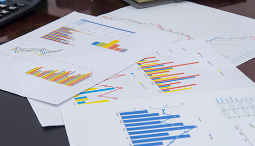 Create a plan for growth A collection of printed charts showing various inflation data, with colorful graphs and bar charts on top of a desk.