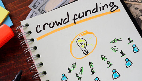Crowdfunding flipping houses Notebook page showing a crowdfunding concept with drawn icons of money and people, illustrating how ideas can be organized visually like an er diagram designed in edrawmax.