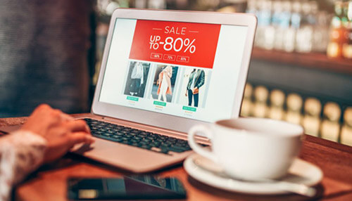 Ecommerce platforms Person shopping online on a laptop during a sale, reflecting how cryptocurrencies influence modern business and digital purchasing trends.