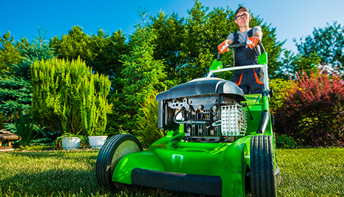 Get equipment Landscaping business owner mowing lawn using professional equipment