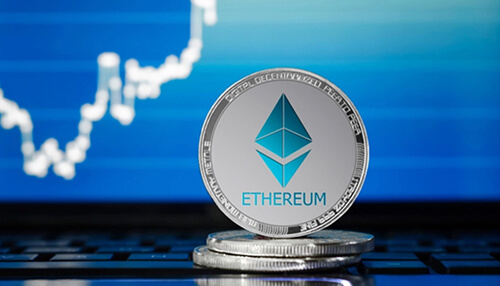 How to buy and trade in eth Silver ethereum coin placed on a laptop keyboard with a rising market chart on the screen, symbolizing digital trading and strategies to trade eth