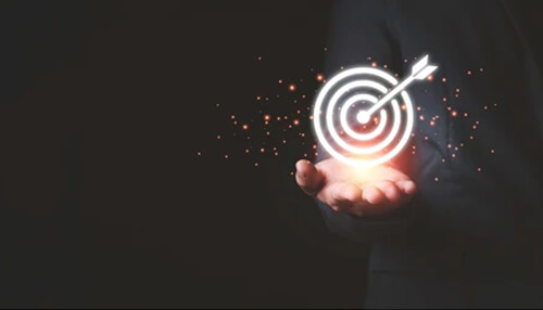 Identify your project objectives Business person holding illuminated target icon with arrow in hand, illustrating strategic goal achievement with a digital transformation partner