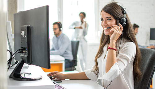 Provide better customer service Customer support representative assisting clients over a headset to improve service quality and increase sales.