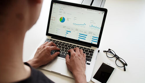 Track your progress A 3d rendering of a stylized blue logo with a bright blue symbol (resembling a'7' or Sigma sign), next to a padlock icon and two credit/debit cards (one green). This represents secure payment and financial tools necessary for Selling Products Online.