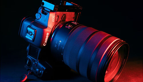 Use high-quality product photography A canon eos r5 mirrorless camera with a 24-70mm lens, highlighted by red and blue light. High-quality photography equipment is crucial for creating appealing visuals when selling products online.