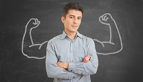 Being confident and in prime condition A confident person standing with arms crossed in front of a chalkboard, symbolizing how neuro linguistic programming (nlp) can help build confidence and prime one's mental state.