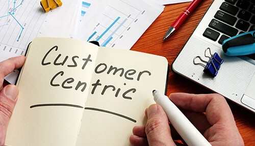 Customer centric Customer advocacy marketing strategy concept showing a notebook with'Customer Centric' written, emphasizing a customer-focused approach in business.