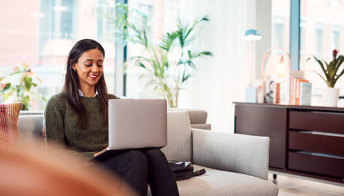 Flexibility bring your own device Professional woman working on a laptop in a modern office, representing the flexibility of bring your own device (byod) policies in the workplace.