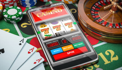 It is simple to use Bluechip casino mobile app gameplay on smartphone, showcasing a slot game on a casino-themed interface with poker chips, playing cards, and roulette.
