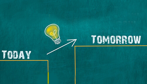 Practice Business growth concept showing “today” to “tomorrow” progression with upward arrow and glowing lightbulb on chalkboard.