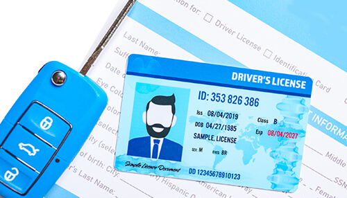 Suspension of driving license - tycoonstory | tycoonstory media Close-up of a driver's license and car key, highlighting important identification details for drivers.