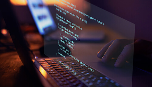 Benefits of codeless or low code automation testing Close-up of code on a laptop screen, representing the use of codeless automated testing tools in a development environment