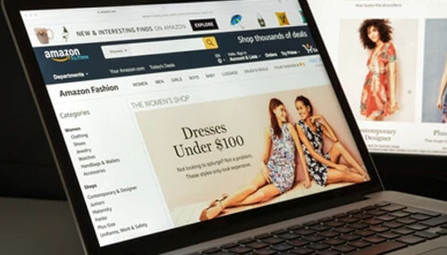 Helps choose the ideal selling price for your goods A close-up view of a laptop displaying the amazon fashion website, with a focus on the'Dresses Under $100' section, showcasing online shopping for fashion.